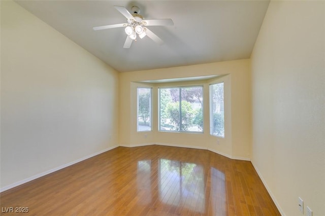 2078 Joy Creek Ln, Henderson, NV 89012 - empty room featuring baseboards, wood finished floors, a ceiling fan, and lofted ceiling