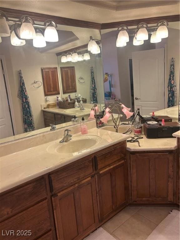 bathroom with tile patterned floors, crown molding, and vanity