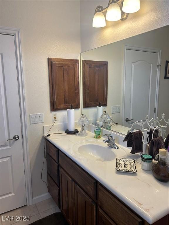 bathroom featuring tile patterned floors, vanity, and baseboards