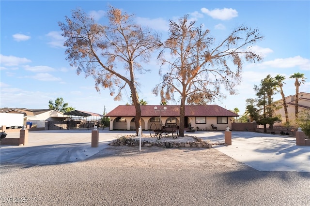 711 Sari Dr, Las Vegas, NV 89110 - ranch-style house featuring driveway, stucco siding, and a carport