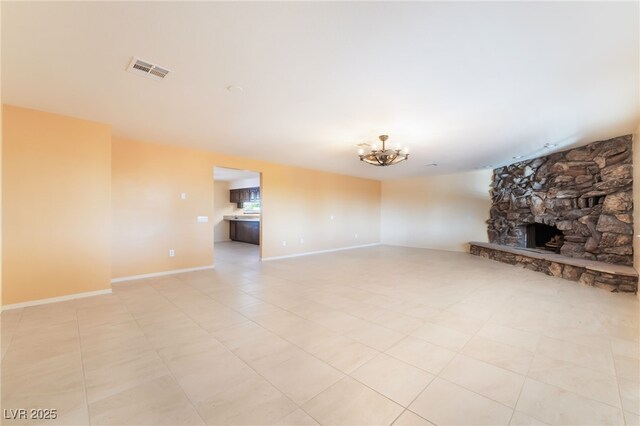 711 Sari Dr, Las Vegas, NV 89110 - unfurnished living room with a chandelier, a stone fireplace, and light tile patterned flooring