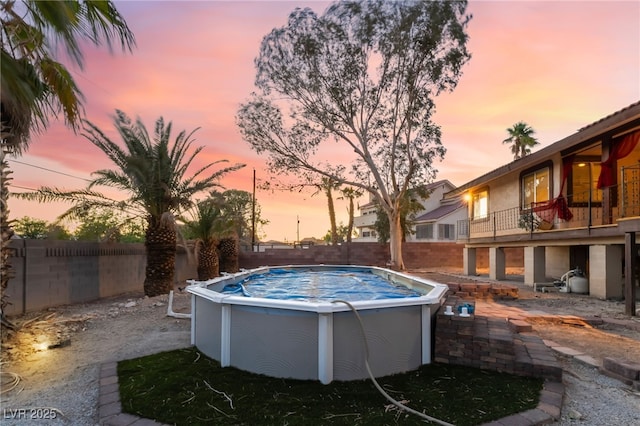 711 Sari Dr, Las Vegas, NV 89110 - pool at dusk with a fenced backyard