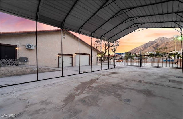711 Sari Dr, Las Vegas, NV 89110 - parking at dusk with a mountain view, a garage, and a detached carport