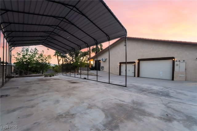 711 Sari Dr, Las Vegas, NV 89110 - view of parking featuring driveway, a detached carport, and a garage