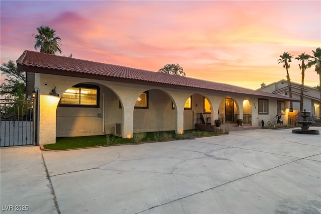 711 Sari Dr, Las Vegas, NV 89110 - mediterranean / spanish-style home with covered porch, stucco siding, driveway, and a tile roof