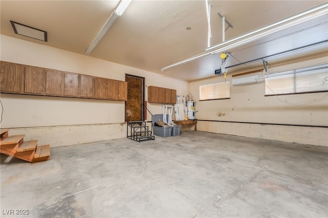 711 Sari Dr, Las Vegas, NV 89110 - garage with a garage door opener, strapped water heater, and an AC wall unit