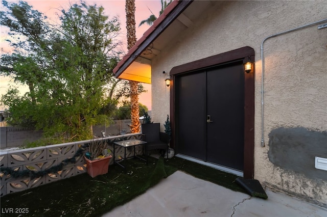 711 Sari Dr, Las Vegas, NV 89110 - exterior entry at dusk with stucco siding