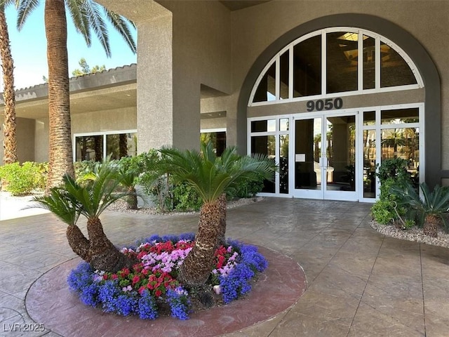 doorway to property with french doors and stucco siding