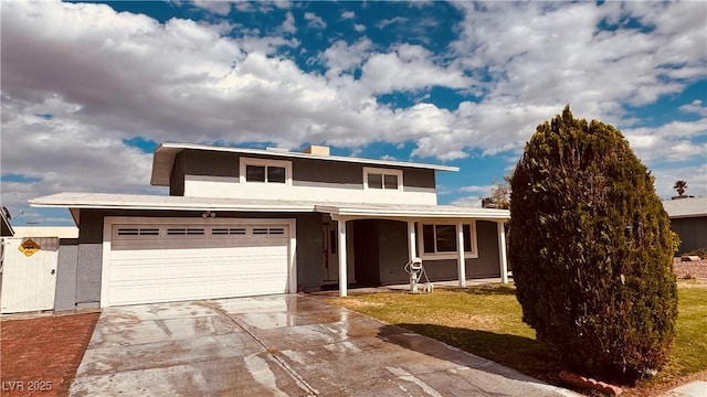 201 Redstone St, Las Vegas, NV 89145 - traditional-style house featuring a front yard, a garage, covered porch, driveway, and stucco siding