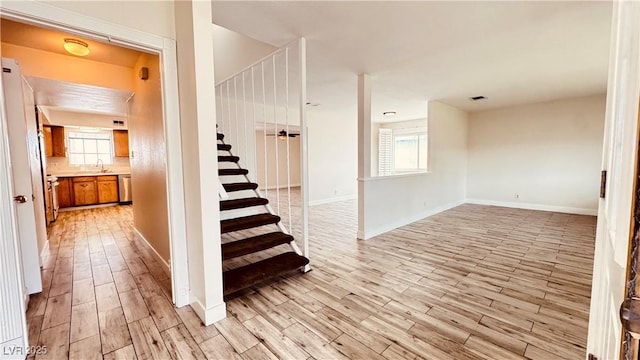 201 Redstone St, Las Vegas, NV 89145 - stairway featuring wood finished floors, plenty of natural light, visible vents, and baseboards