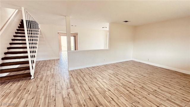 201 Redstone St, Las Vegas, NV 89145 - unfurnished living room featuring baseboards, visible vents, wood finished floors, and stairs