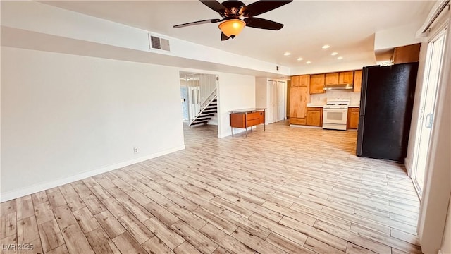 201 Redstone St, Las Vegas, NV 89145 - kitchen featuring light wood-style floors, visible vents, white range with gas cooktop, and freestanding refrigerator
