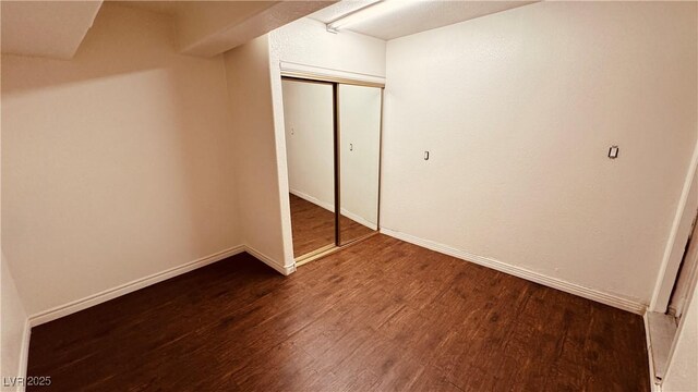 201 Redstone St, Las Vegas, NV 89145 - unfurnished bedroom with a closet, baseboards, and dark wood finished floors
