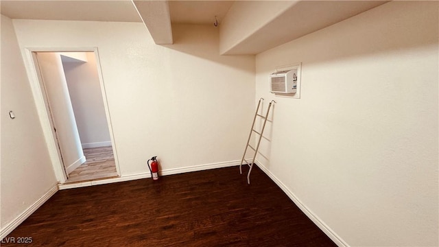 201 Redstone St, Las Vegas, NV 89145 - finished below grade area featuring baseboards, a wall mounted air conditioner, and wood finished floors