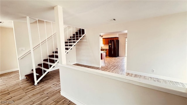 201 Redstone St, Las Vegas, NV 89145 - staircase featuring visible vents, wood finished floors, and baseboards
