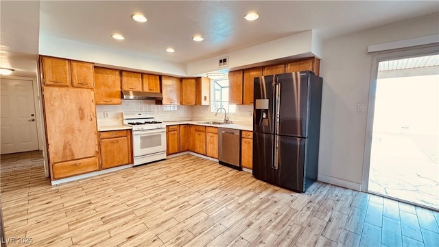201 Redstone St, Las Vegas, NV 89145 - kitchen with white gas range oven, a sink, under cabinet range hood, dishwasher, and fridge with ice dispenser