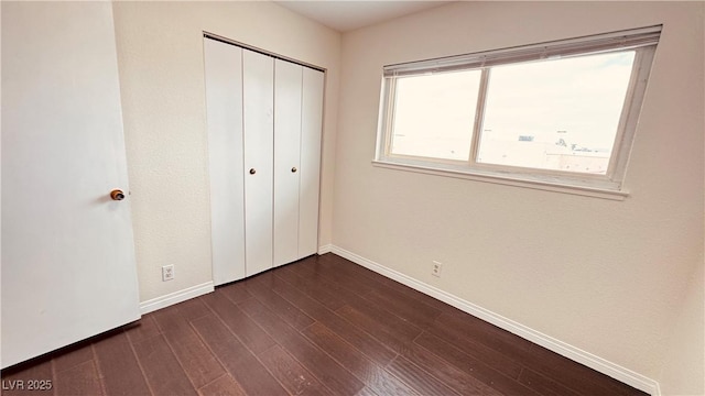 201 Redstone St, Las Vegas, NV 89145 - unfurnished bedroom with baseboards, dark wood-style flooring, and a closet