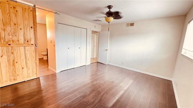 201 Redstone St, Las Vegas, NV 89145 - unfurnished bedroom with visible vents, ensuite bath, wood finished floors, and baseboards