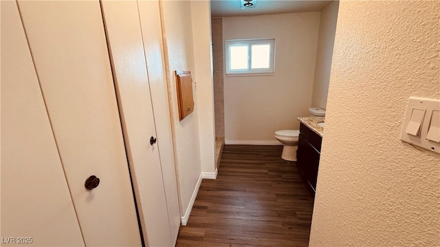 201 Redstone St, Las Vegas, NV 89145 - bathroom featuring baseboards, wood finished floors, toilet, and a textured wall