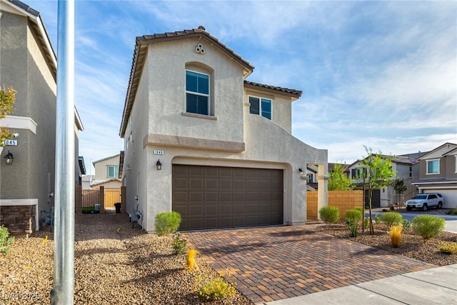 1049 Williamtown Ave, North Las Vegas, NV 89084 - mediterranean / spanish-style home with a garage, stucco siding, a tiled roof, and fence