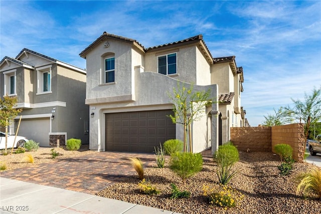 1049 Williamtown Ave, North Las Vegas, NV 89084 - view of front of home with fence, decorative driveway, an attached garage, and stucco siding