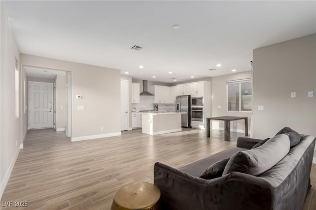 1049 Williamtown Ave, North Las Vegas, NV 89084 - living room with recessed lighting, visible vents, light wood-style flooring, and baseboards