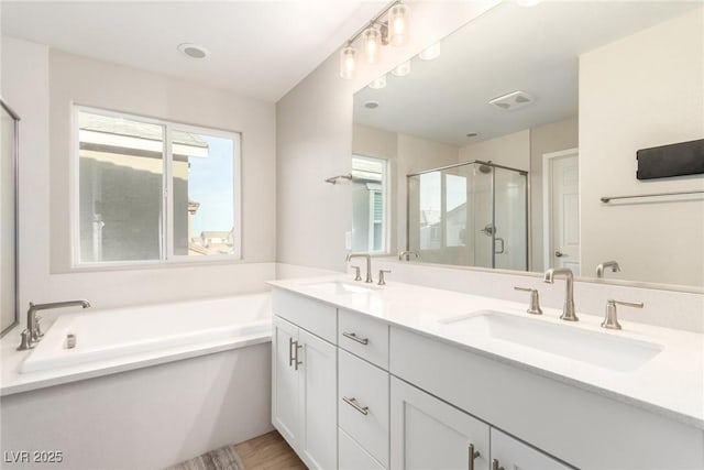 1049 Williamtown Ave, North Las Vegas, NV 89084 - full bathroom with visible vents, a stall shower, a bath, and a sink