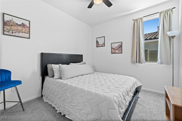 carpeted bedroom featuring ceiling fan and baseboards