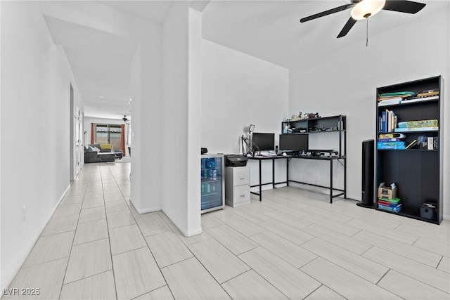 office with ceiling fan and baseboards