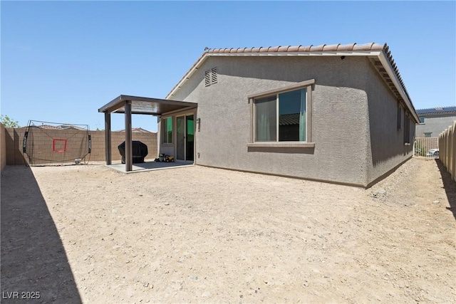 back of property featuring a patio, a fenced backyard, and stucco siding