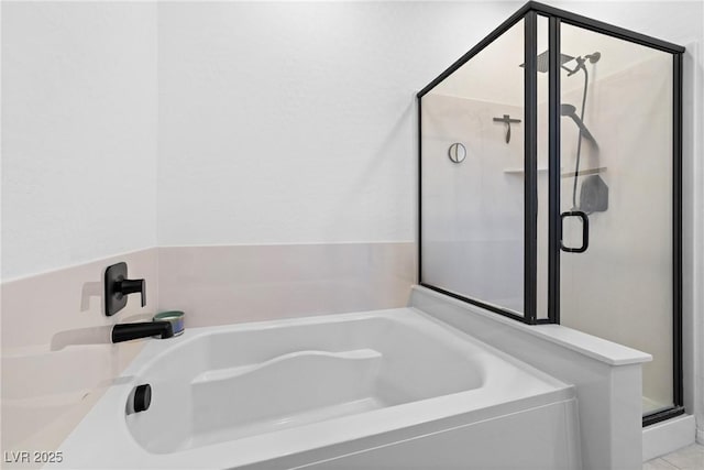 full bath featuring a garden tub and a stall shower