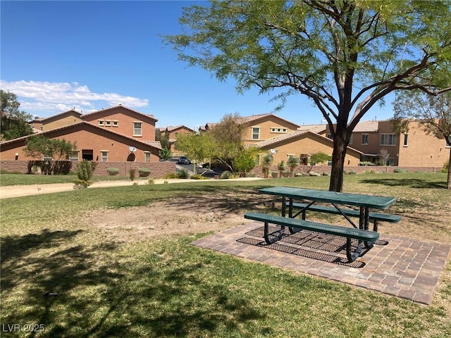 view of property's community with a residential view and a yard