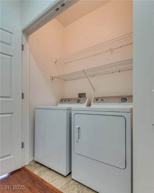 1139 Via Partito, Henderson, NV 89052 - laundry area with independent washer and dryer, light wood-type flooring, and baseboards