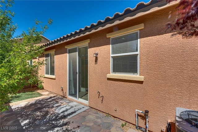 1139 Via Partito, Henderson, NV 89052 - back of house featuring stucco siding, a patio area, a tile roof, and cooling unit