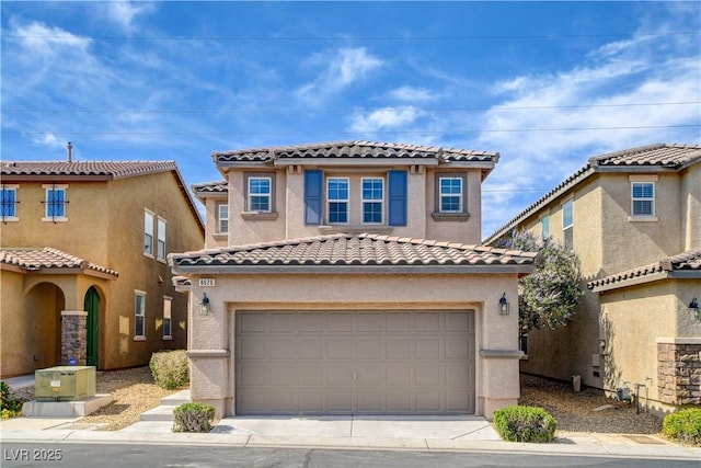 8626 Anderson Dale Ave, Las Vegas, NV 89178 - mediterranean / spanish home featuring an attached garage, a tiled roof, stucco siding, and concrete driveway