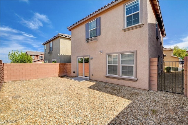 8626 Anderson Dale Ave, Las Vegas, NV 89178 - rear view of property with stucco siding, a tiled roof, a fenced backyard, and a gate