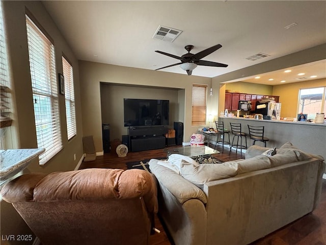 8396 Waylon Ave, Las Vegas, NV 89178 - living room featuring dark wood finished floors, visible vents, a ceiling fan, and baseboards