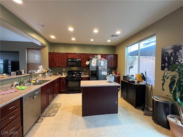 8396 Waylon Ave, Las Vegas, NV 89178 - kitchen with recessed lighting, light countertops, black appliances, a sink, and a center island