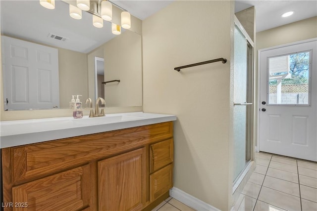 full bathroom with tile patterned flooring, vanity, baseboards, a shower stall, and visible vents