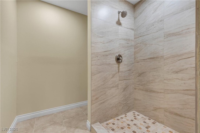 full bathroom featuring tile patterned floors, baseboards, and tiled shower