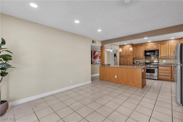 kitchen featuring baseboards, recessed lighting, a peninsula, and stainless steel appliances