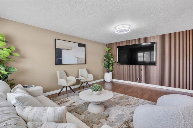 living area featuring baseboards and wood finished floors