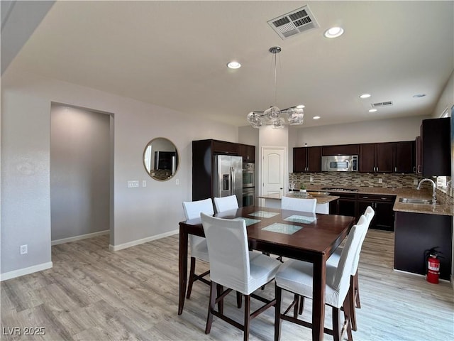 dining space with recessed lighting, baseboards, visible vents, and light wood finished floors