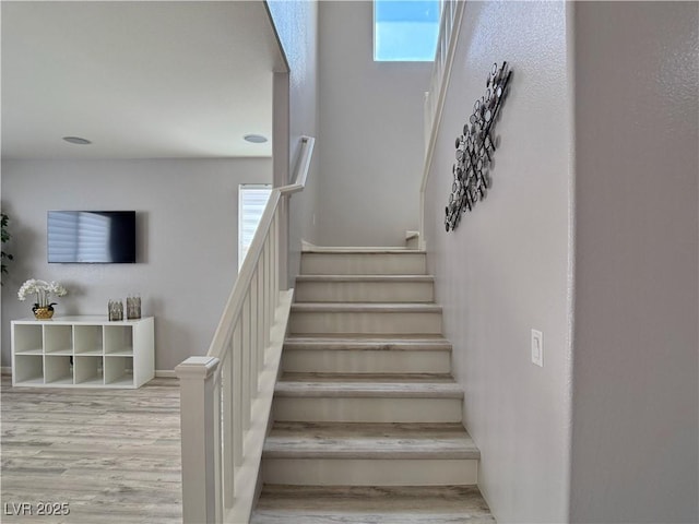 stairway featuring wood finished floors