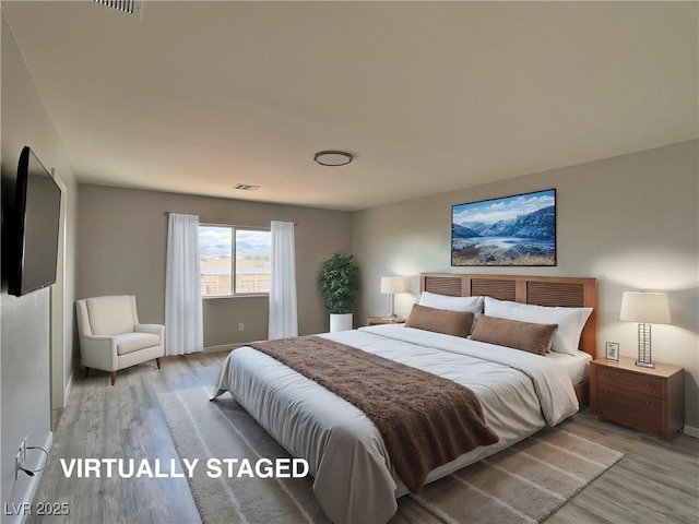 bedroom with light wood-type flooring, baseboards, and visible vents
