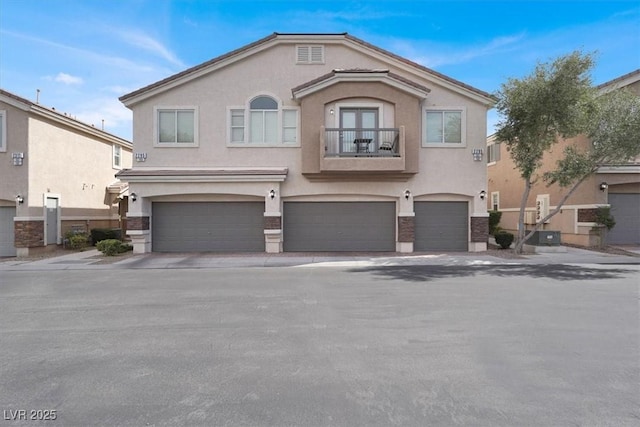 view of front of property with driveway, a garage, cooling unit, a balcony, and stucco siding
