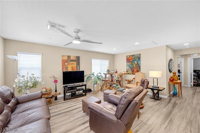 living room with a ceiling fan, visible vents, baseboards, recessed lighting, and light wood-style flooring