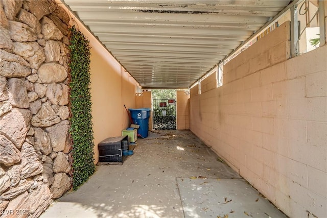 view of side of home featuring stucco siding and fence