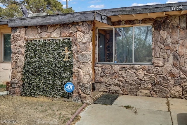 view of property exterior with stone siding