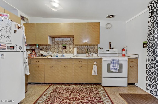 kitchen featuring light brown cabinetry, white appliances, light countertops, tasteful backsplash, and a sink